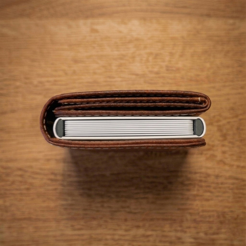 Top view of a slim full grain leather wallet with minimalist design, thin profile, and compact structure for everyday carry.