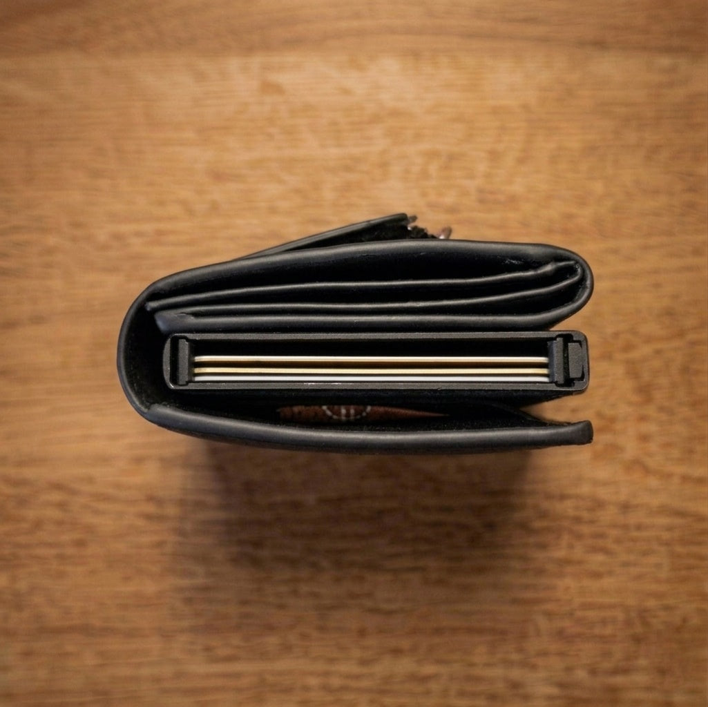 Top view of a standard wallet from another brand showing bulkier design and thicker profile compared to a slim wallet.